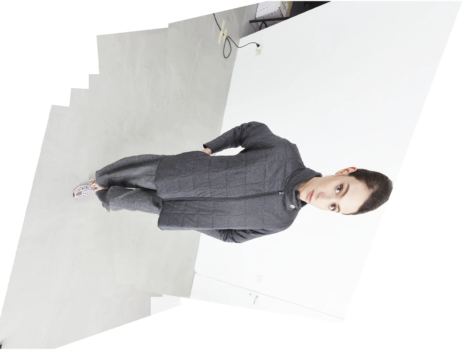 Photo shoot for a fashion brand: total grey look with minimal style in the studio.